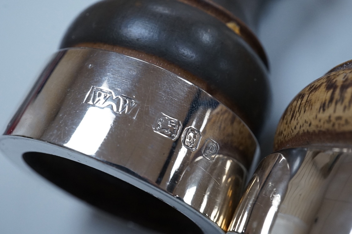 Two modern silver mounted pepper mills, 10.5cm, one other silver pepper mill by Hukin & Heath, Birmingham, 1926 and a pair of George III silver bun shaped salts, David Hennell I, London, 1750, with blue glass liners.